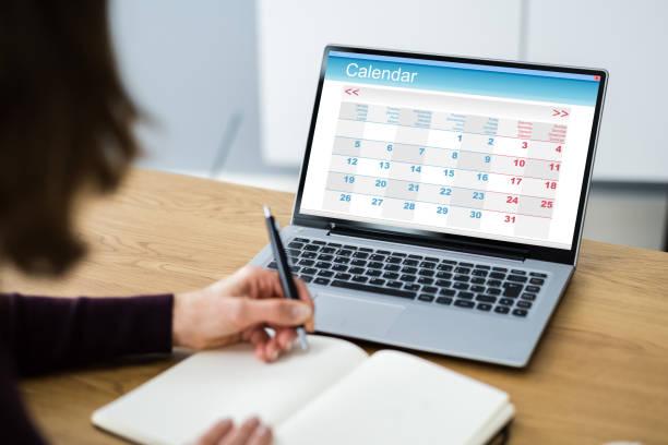 istock Looking At Calendar Agenda Schedule 1296689058