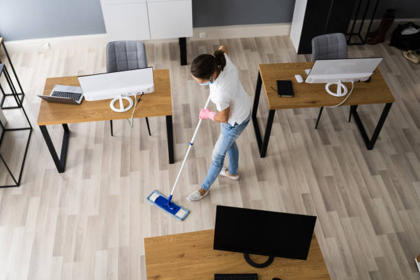 istock Female Janitor Mopping Floor In Face Mask 1296689103