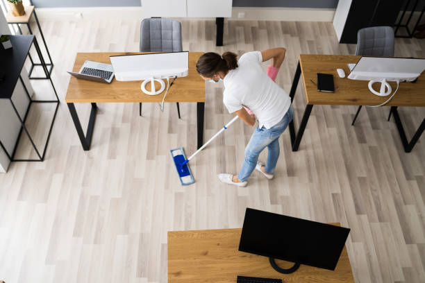 istock Female Janitor Mopping Floor In Face Mask 1296689106