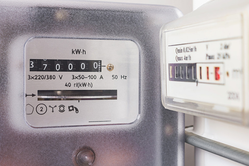 Electricity meter and gas meter. Utility bills, consumption of electricity and gas for heating home, energy costs, symbolic image. Selective focus