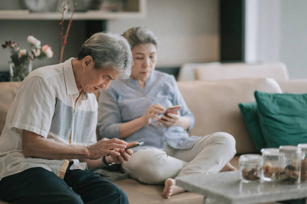 istock asian chinese senior couple with presbyopia having difficulty  trying to learn using smart phone at living room during weekend leisure time 1296689984