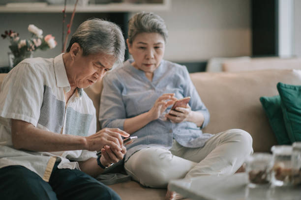 istock asian chinese senior couple with presbyopia having difficulty  trying to learn using smart phone at living room during weekend leisure time 1296690019