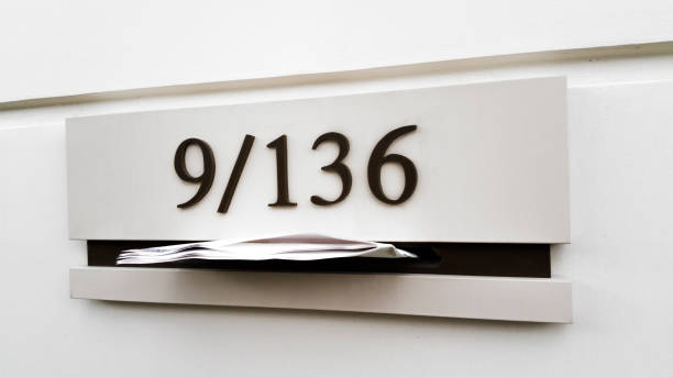 istock Metal mail box on concrete wall building 1296690511