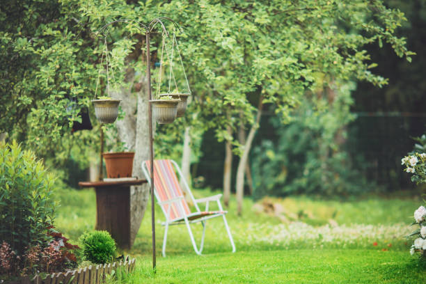 istock Beautiful garden with trees, lawn with green grass 1296691427