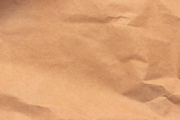 istock Texture of crumpled light brown craft paper. 1296692016