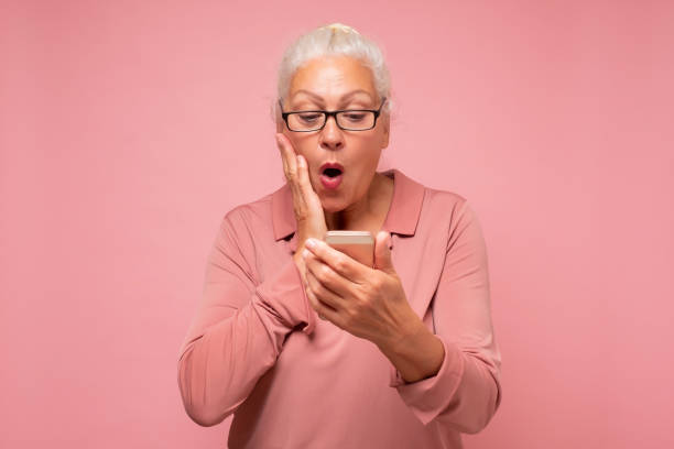 istock Surprised senior woman with wrinkles is using her smartphone sending a messag 1296692120