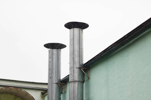 Two pipes on a green building close up