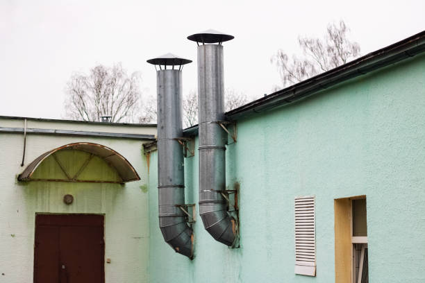 istock Two pipes on a green building at the door 1296692150