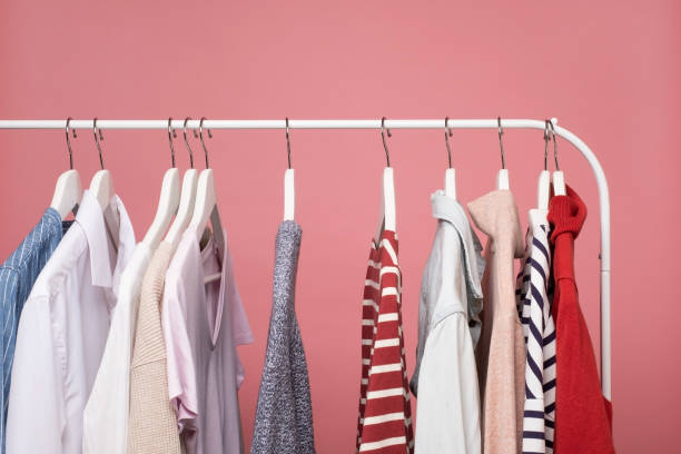 istock Clothes hang on a shelf in a clothes store 1296692806