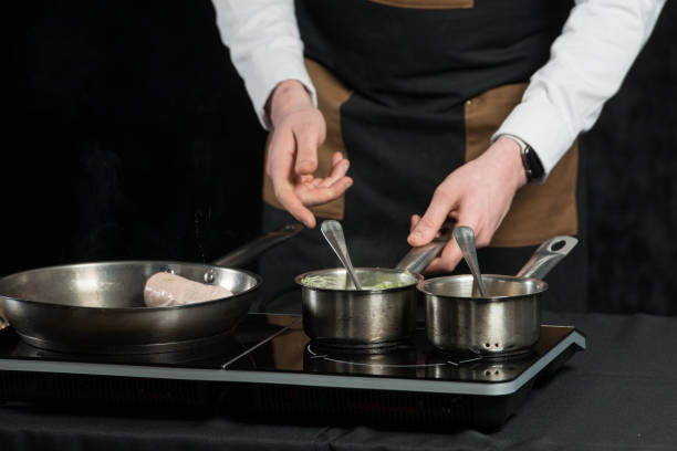 istock man cooking meat and sauce on a induction cooker 1296694559