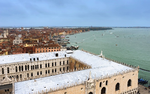 Venice, Italy, March 30, 2016: Aerial view of the Doge´s Palace and the  south bank of Castello quarter of Venice in Venetian Lagoon under cloudy sky. The entire lagoon is listed as UNESCo World Heritage Site.