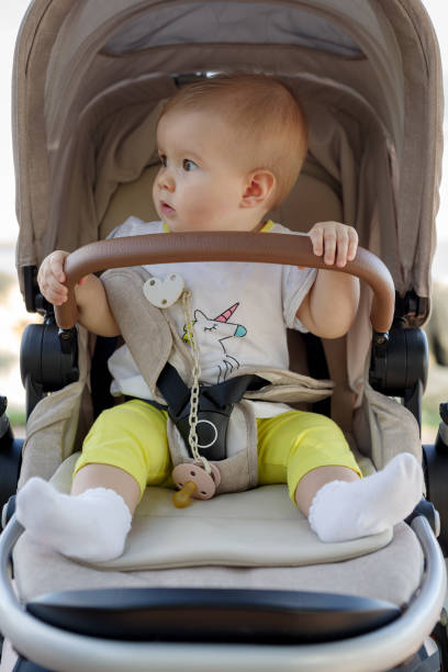 istock Baby girl sitting in stroller 1296696774
