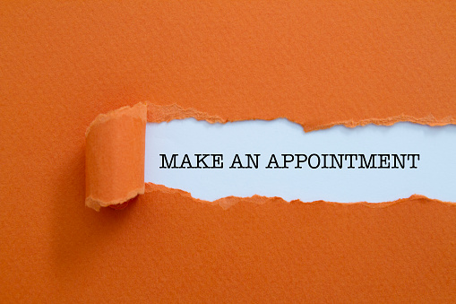 Make an appointment written under torn paper.