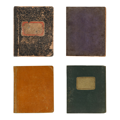 Close-up of old notebook covers (approx. 1900) isolated on white background.