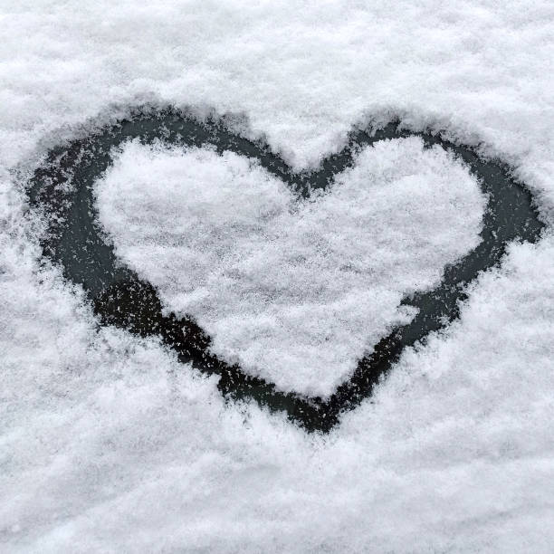 istock Heart drawn on a snow-covered car. Close up 1296700183