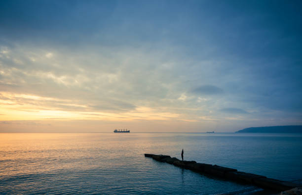 relaxing in beautiful landscape on pier at sunset
