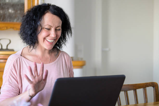 istock Woman waving to the computer 1296700564