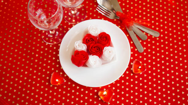 istock A white plate with a knife and fork on a bright red background 1296701596
