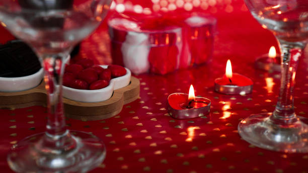 istock Candles for valentines day, table with festive red background 1296702720