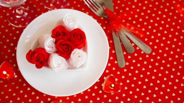 istock A white plate with a knife and fork on a bright red background 1296702849