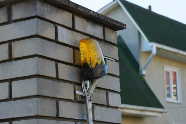 istock one yellow signal light hanging on a white brick wall 1296703000