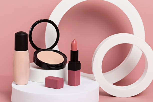 istock Make up products prsented on white podiums on pink pastel background. 1296704644