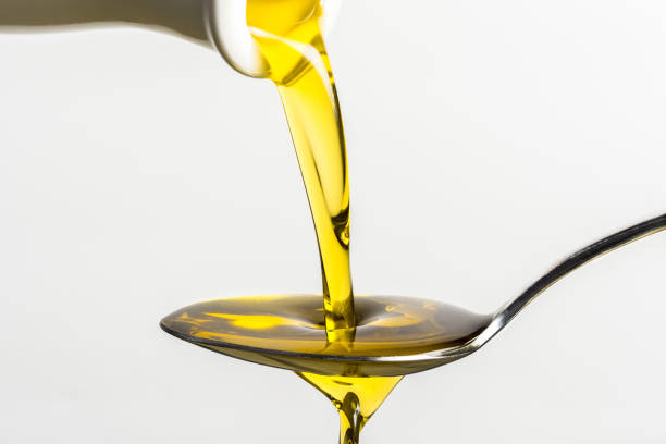 istock Pouring Olive Oil on a Spoon 1296705873