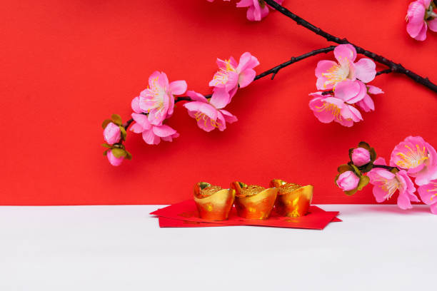 istock Sakura Blossom, Golden Ingot on top of Red Envelope 1296706155