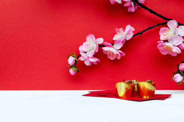 istock Sakura Blossom, Golden Ingot on top of Red Envelope 1296706168