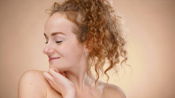 istock Bare-shouldered young woman in a studio with closed eyes 1296707091