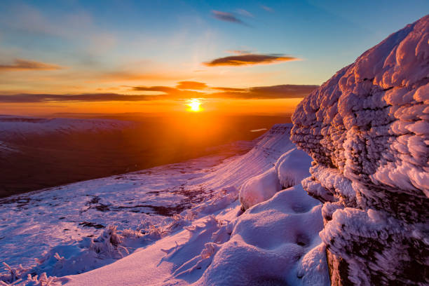 istock Beautiful sunrise over a cold, snow covered mountain 1296708690