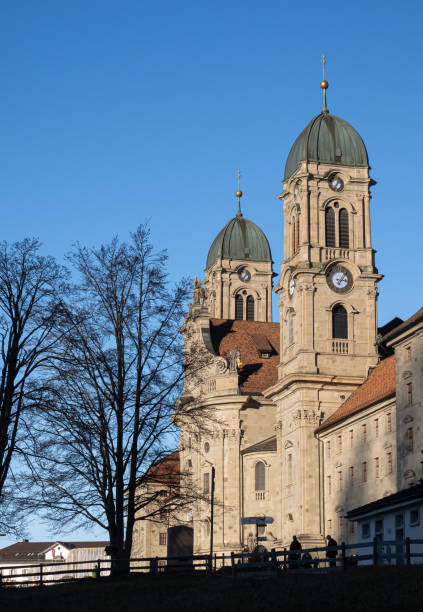 The Abbey of Einsiedeln is one of the most important baroque monastic sites and the largest place of pilgrimage in Switzerland. The image shows the building exterior with the two towers and the main entrance.