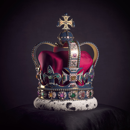 Royal golden crown with jewels on pillow on black background. Symbols of UK United Kingdom monarchy. 3d illustration