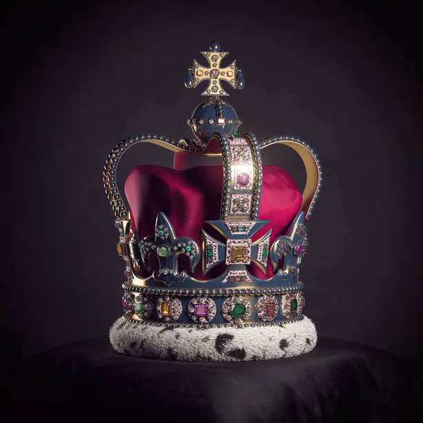 Photo of Royal golden crown with jewels on pillow on black background. Symbols of UK United Kingdom monarchy.