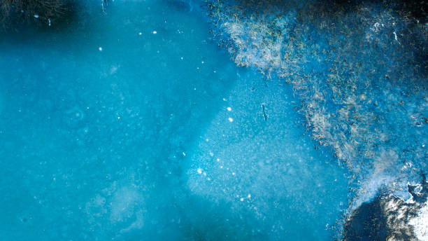 istock Frozen fishpond - aerial view 1296713798