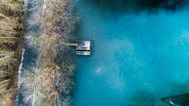 istock Frozen fishpond - aerial view 1296713810