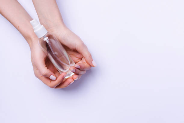 istock Hands holding spray on white background with empty advertising space. 1296714705