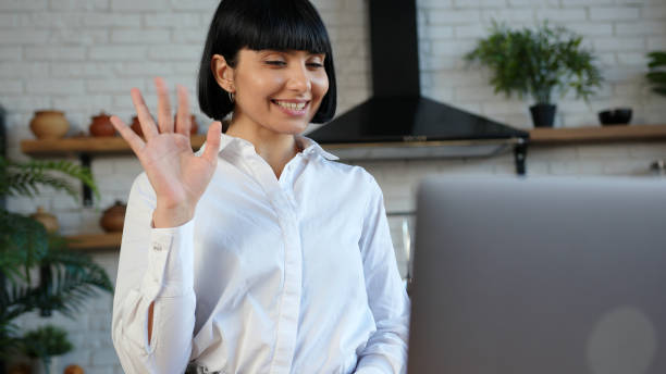 istock Young lady with elegant haircut has videocall on laptop 1296715106