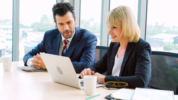 istock Two business people talk project strategy at office 1296716301