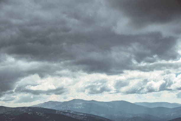 istock Thick clouds over mountain range, hills in blue haze 1296716945