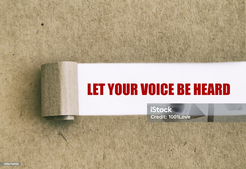 Let your voice be heard written under torn paper. Listening Stock Photo