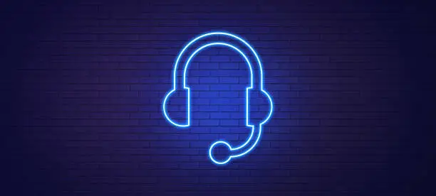 Photo of Headset Symbol Drawn by Blue Neon Light on Black Wall