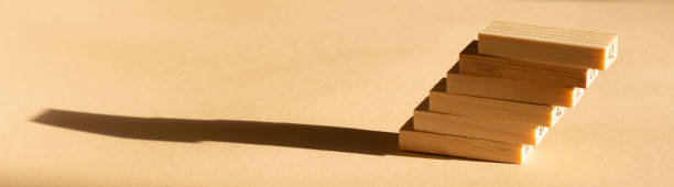 istock shadows from the wooden blocks on a beige background. Abstract 1296719631