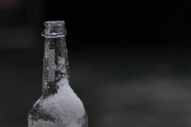 Soda bottles under ice in a cooler.