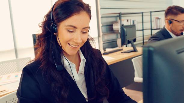 istock Business people wearing headset working in office 1296720219