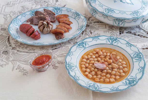 istock Spanish Chickpea Stew with meat. Elegant crockery. Traditional table. Embroidered tablecloth 1296722178