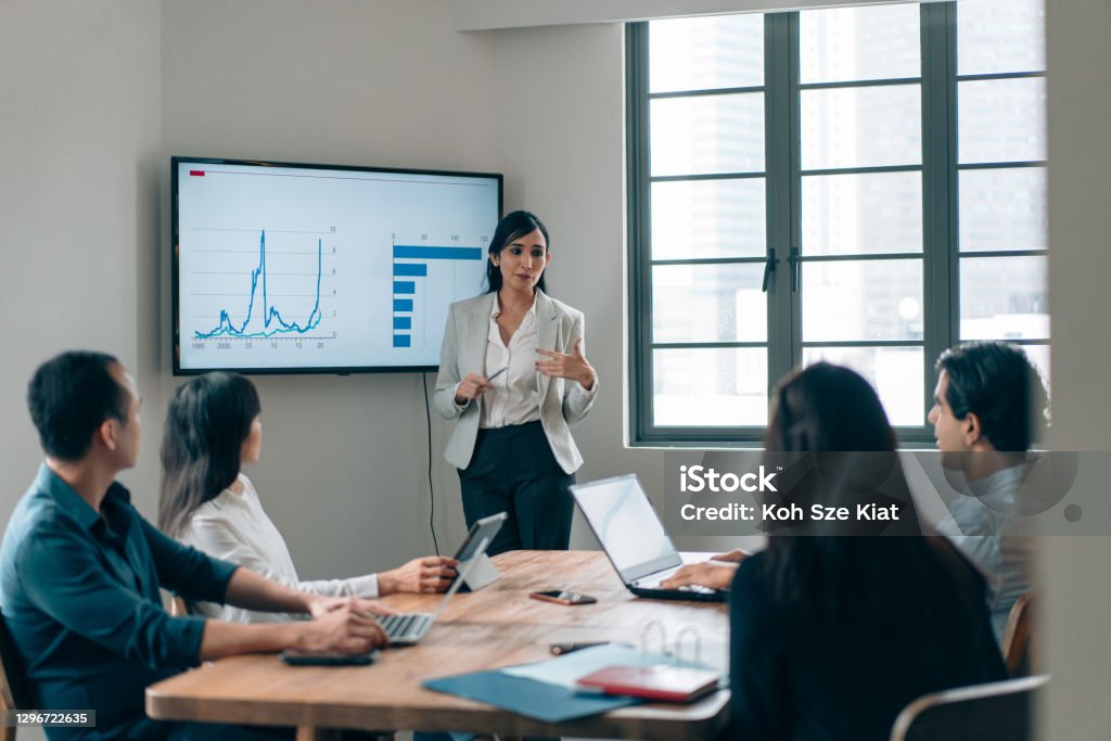 Gender stereotype - Female leadership in a small business meeting Manager Stock Photo