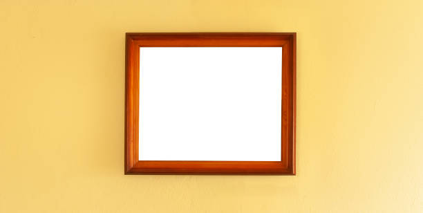 istock Wooden mockup frame placed on a yellow wall. Gallery interior design concept. 1296723566