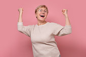 Excited aged senior female look at camera scream yes feel euphoric.