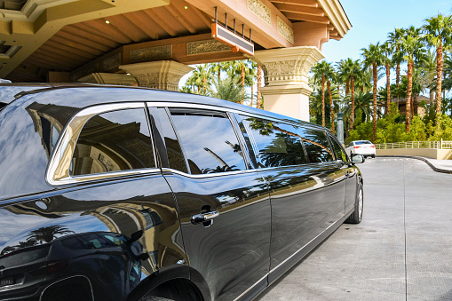 Las Vegas, Nevada, USA - February 2019: Stretched limo parked in front of the entrance to the Mandelay Bay hotel on Las Vegas Boulevard, which is also know as the Las Vegas Strip.